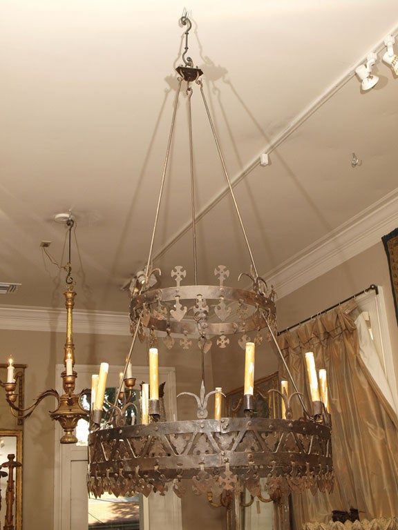 A nine light, two tier chandelier with the candleholders alternating with tulip form decoration.