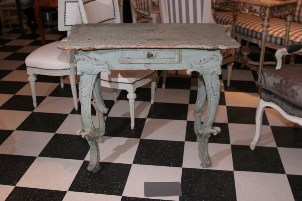 A side table in an aqua blue original paint. Made in Austria during the Rococo period ca 1720-1750. The table is decorated with swirl carvings and a molded edge. Drawer in frieze with original hardware. 