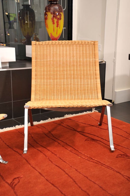 Poul Kjaerholm lounge chairs. Matte chrome-plated steel and cane. Impressed manufacturer's marks to underside. E Kold Christensen Denmark.