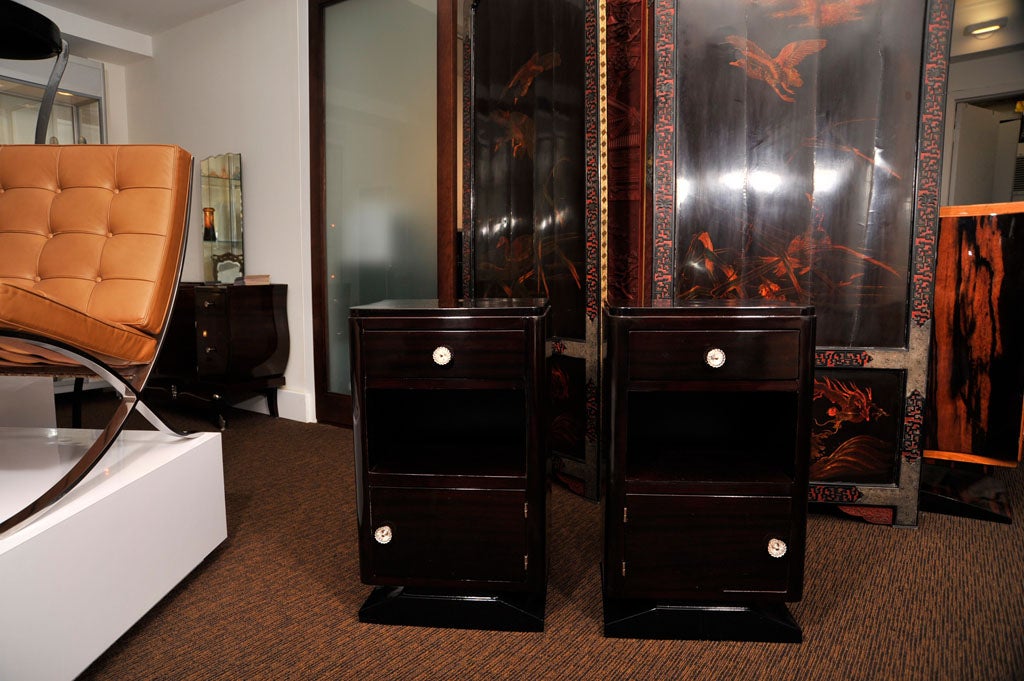 Pair of French Art Deco mahogany night stands with crystal hardware, a single top drawer above compartment and cabinet door.