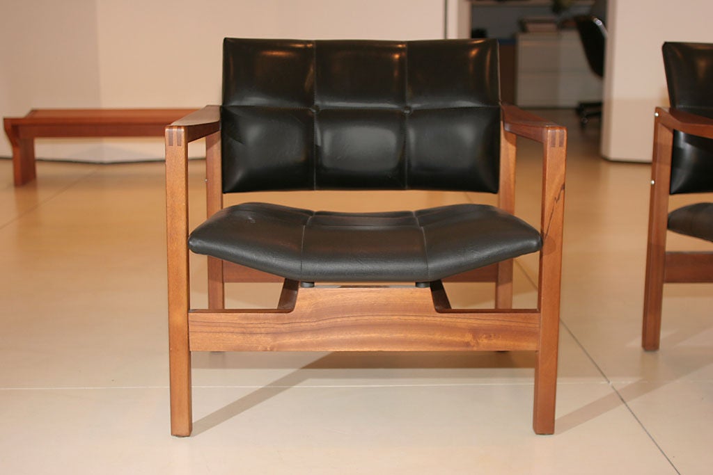 Michel Mortier.

A pair of wood armchairs with vinyl seats.