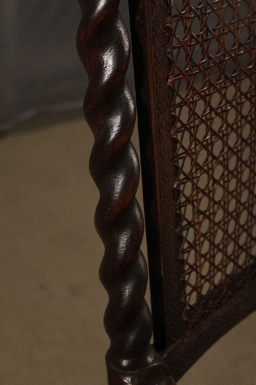 Early 18th Century English caned and carved walnut arm chair in the Jacobean taste.