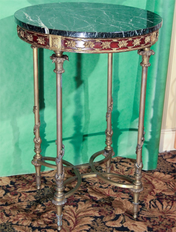 Round brass and marble top side table. Mahogany with brass pillar legs.
