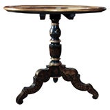 Painted black and gilt round tilt top table.
