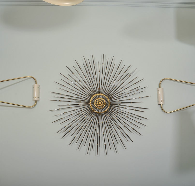 Whimsical wall decoration made of welded hand hammered nails, each weld is then enhanced by gilding.