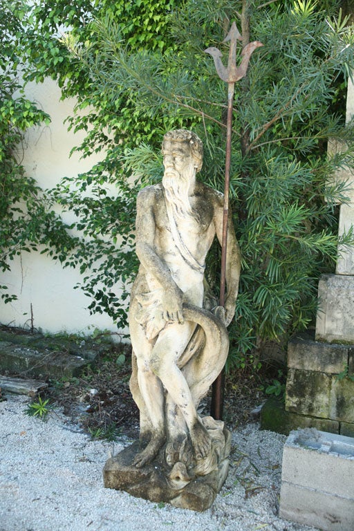 Neptune with trident in a classical position holding a dauphin grotesque with his right hand. This magnificent statue was used as a fountain head. Beautiful patina.