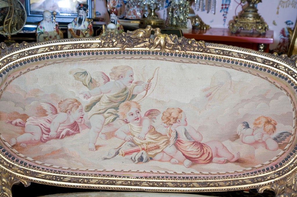 1830s gilded French settee with origional Aubusson tapastry textile..angels,cherubs,woves. Gilded frame has birds at top~Also additonal side chair sold seperatley...belongs in a rock stars dressing room.<br />
The perfect fabric is perfect