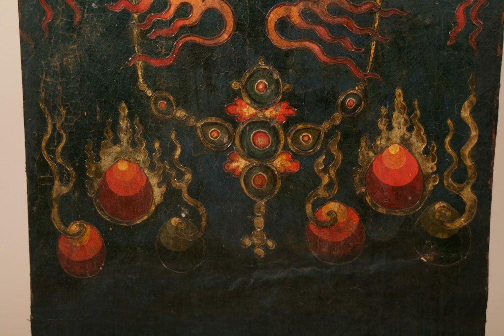A monastery door depicting one of the Dharmapalas, the protectors of the laws of Buddhism.  This depiction is likely of Mahakala with stylized flames. <br />
<br />
Call for more detailed information.