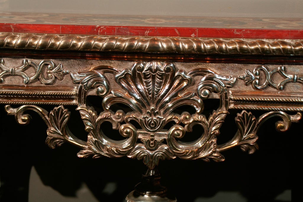 Unique baroque style table with ornate carved based and intricate marble inlay design.
