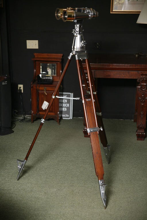 A pair of WWII English made Ross Binoculars, on a sturdy wood and metal tripod.