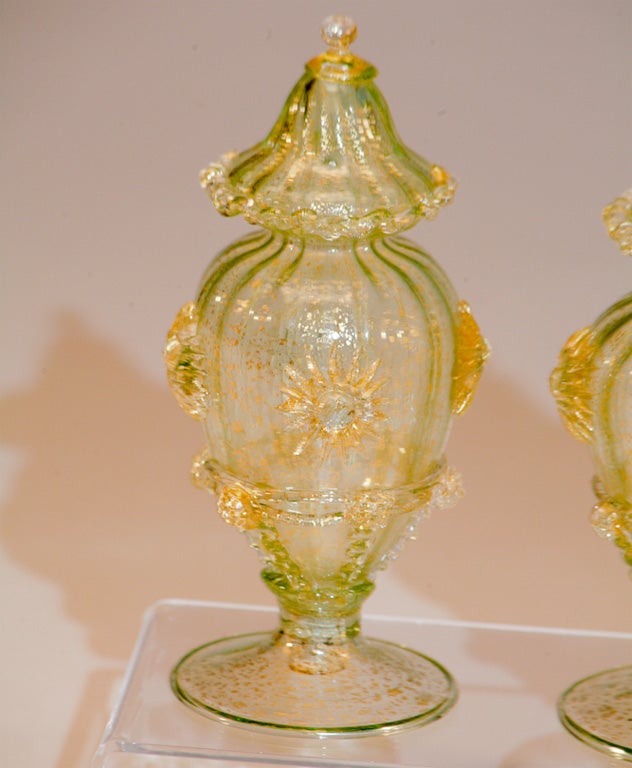 This pair of Venetian hand blown oversized salt and pepper shakers are actually a soft green color and filled with gold leaf inclusions, made by Salviati. There is applied rigaree, stars and prunts. The large proportion makes them a rare pair that