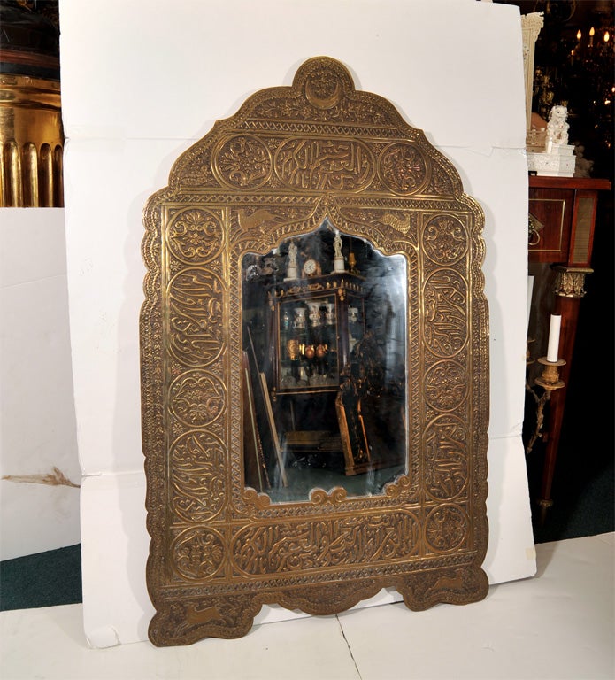 This metal mirror features extensive embossed decoration including Arabic calligraphy and animal figures.  It dates from the late nineteenth century and is possibly of Syrian origin.
Stock Number: F2