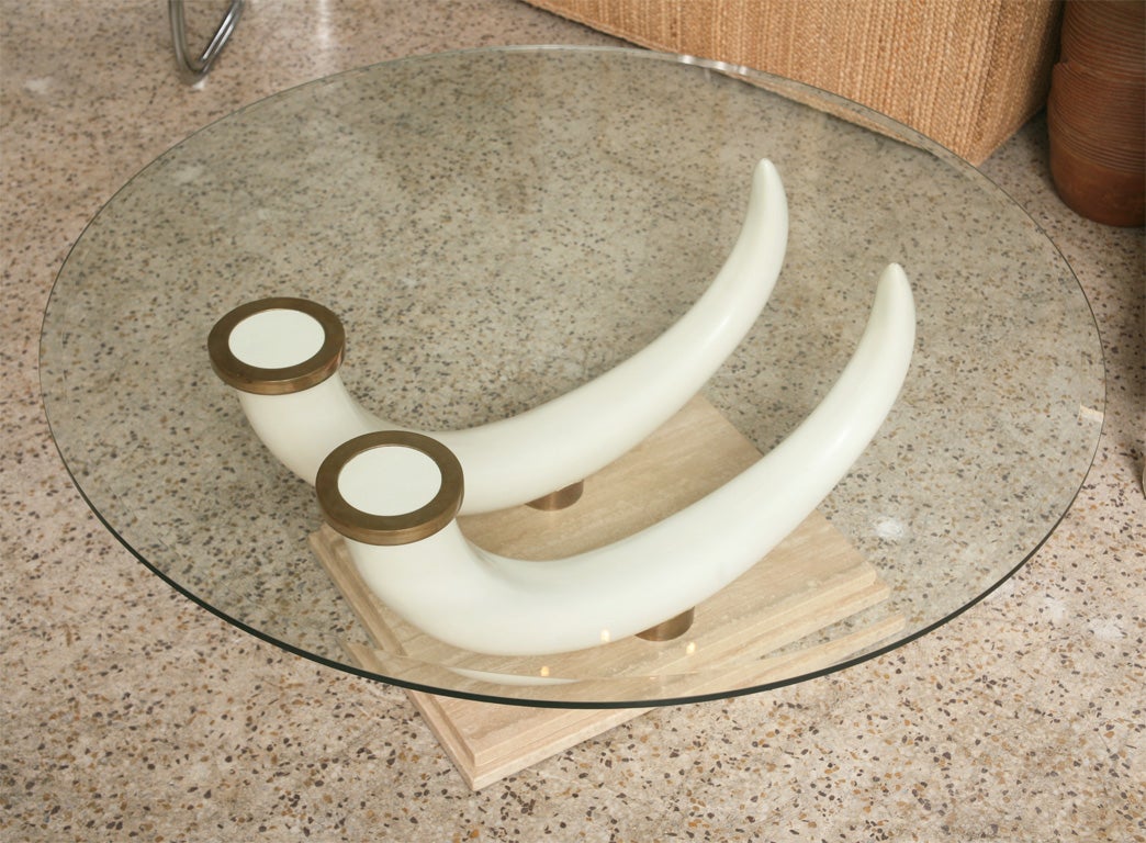 Lovely faux ivory tusk and travertine coffee table in the manner of Maison Jansen. Brass caps and mounts, with a bevelled glass top. Summer Inventory Reduction Sale - Returns to full price June 1st!!