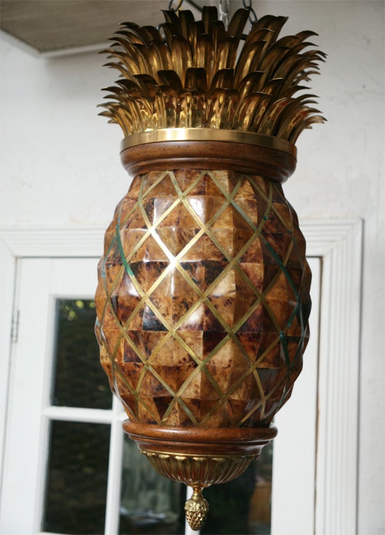 Wonderfully whimsical Maitland Smith hanging pineapple light fixture with brass leaves and strapping.