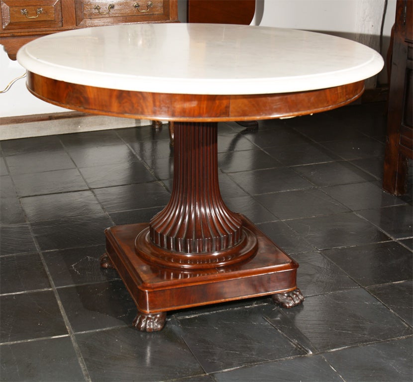 Dutch, marble-top center hall table with fluted column on square base with paw feet; nice transitional design with neoclassic influence.