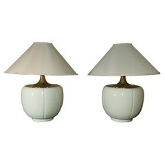 Pair of pale green lamps with brass decorative tops