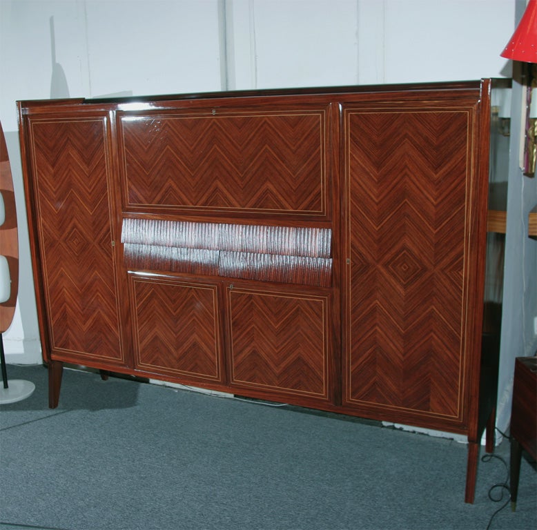 Beautiful rosewood and parquetry credenza with string inlay around frame of the doors, made in Italy, 1950 by Dassi. Mahogany interior with four drawers and 12 shelves, versatile piece, great quality.
 
