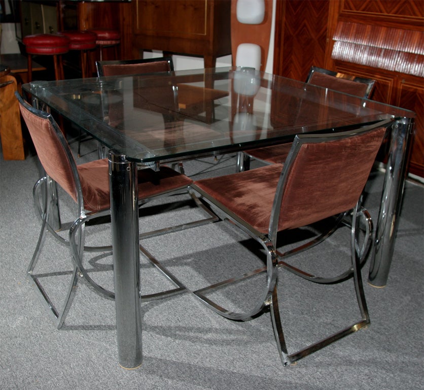 Exciting chrome dining table and 4 chairs, made in 1970 in Milan by Romeo Rega. Unusual construction and great quality.
