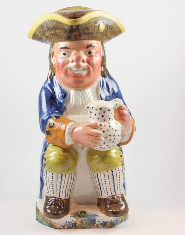 A fine English pearlware toby jug and cover decorated in underglaze Pratt colors