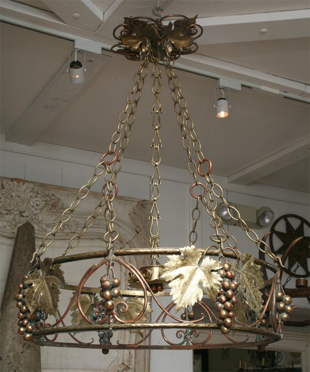 Hand wrought brass and copper chandelier with light suspended in center. Signed Paul Brindeau 1920