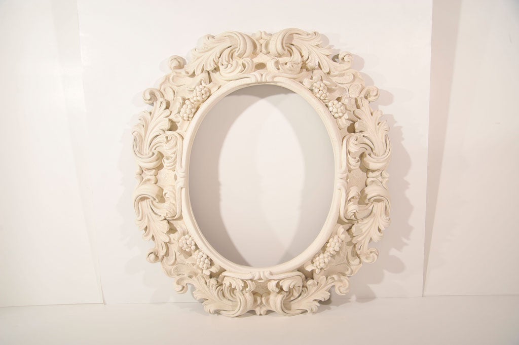 Fanciful reproduction of oval Baroque picture frame with scrolls, leaves, and grape clusters. Fit with clear mirror.