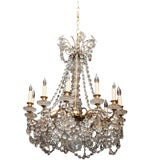 A FRENCH LOUIS 15TH STYLE 12 LIGHT CRYSTAL AND BRONZE CHANDELIER