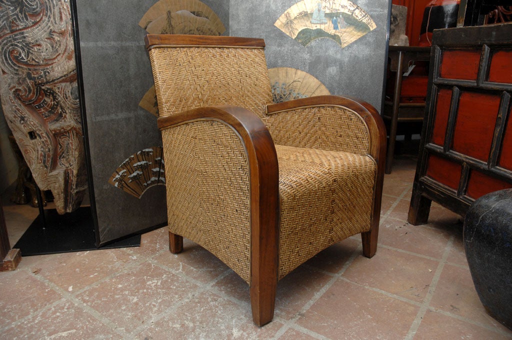 Late 20th century, Indonesian teak club chair with woven cane seat and back.