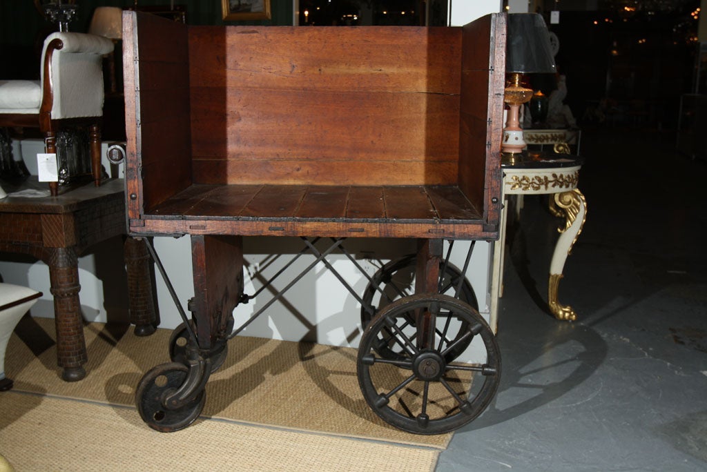 An American wooden factory cart with iron wheels and braces.  Stamped on the reverse with 