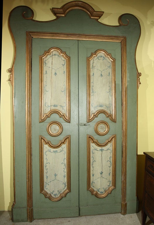 A Venetian painted and parcel gilt frameless paneled door with delicate bellflower decoration.
