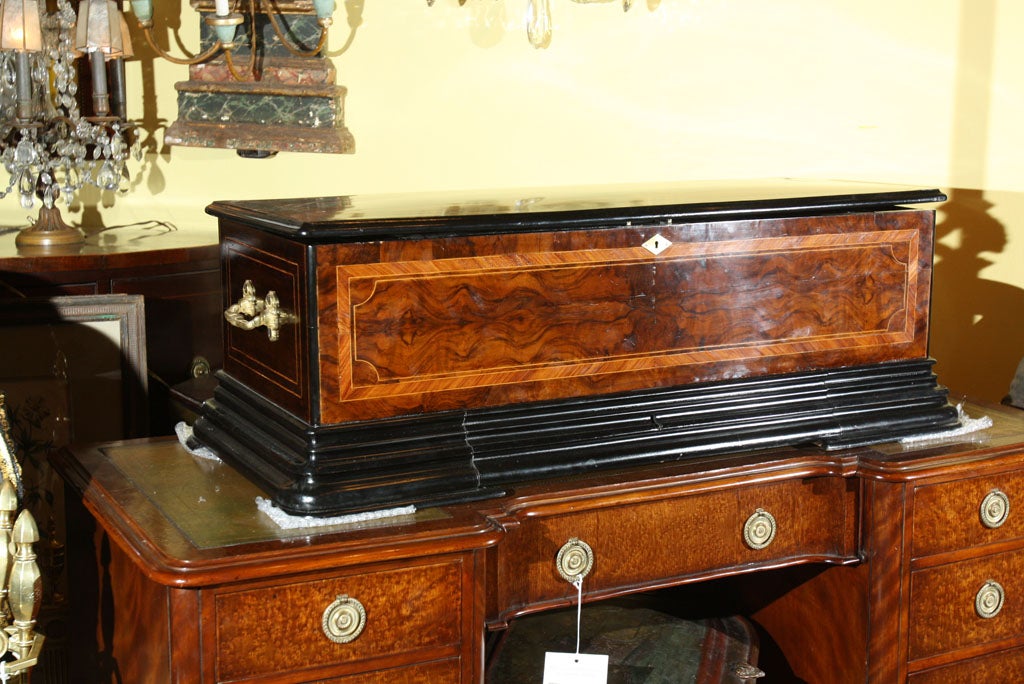 A late 19th century interchangeable cylinder musical box by M.J. Paillard & Co. of New York City, with four cylinders playing six programs. Along with the box is a program guide containing tune sheets for the four cylinders.  Musical box is  burl