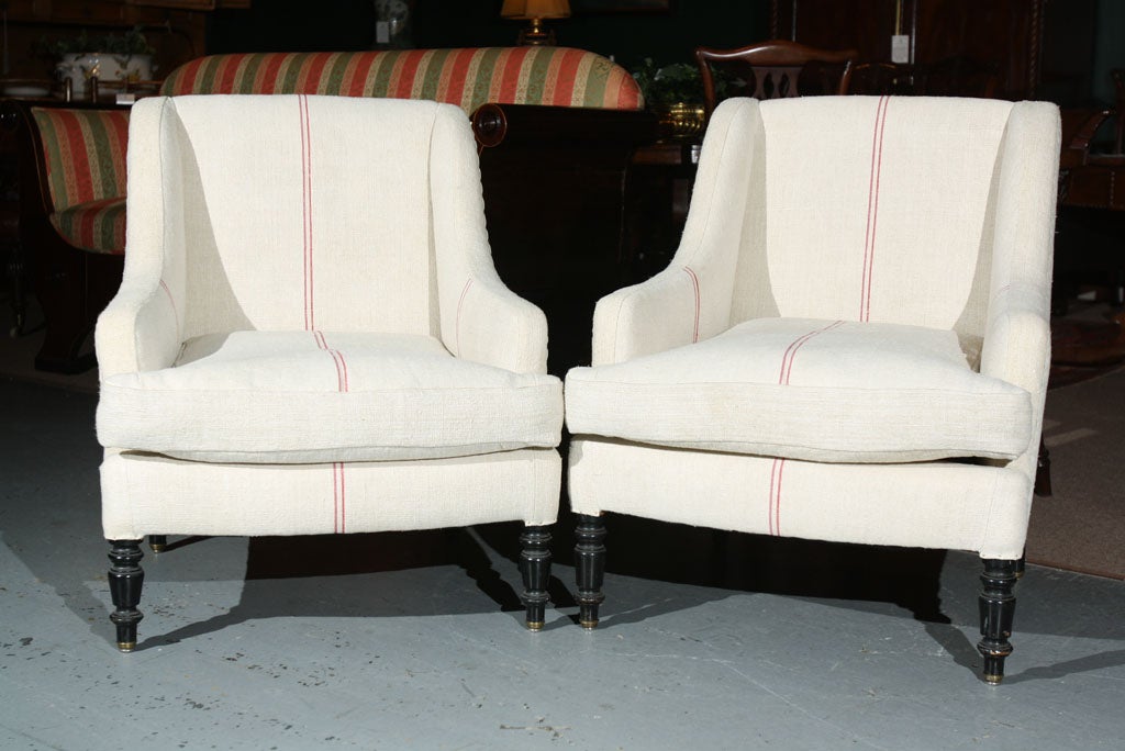 A pair of English Regency armchairs covered in vintage linen.