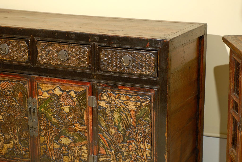 Hand carved and lacquered Mongolian cabinet with 2 doors that have original hardware and 4 drawers.  This piece is exceptional and the amount of detail is something that is rarely seen in Mongolian pieces.  The doors and panels on the face of
