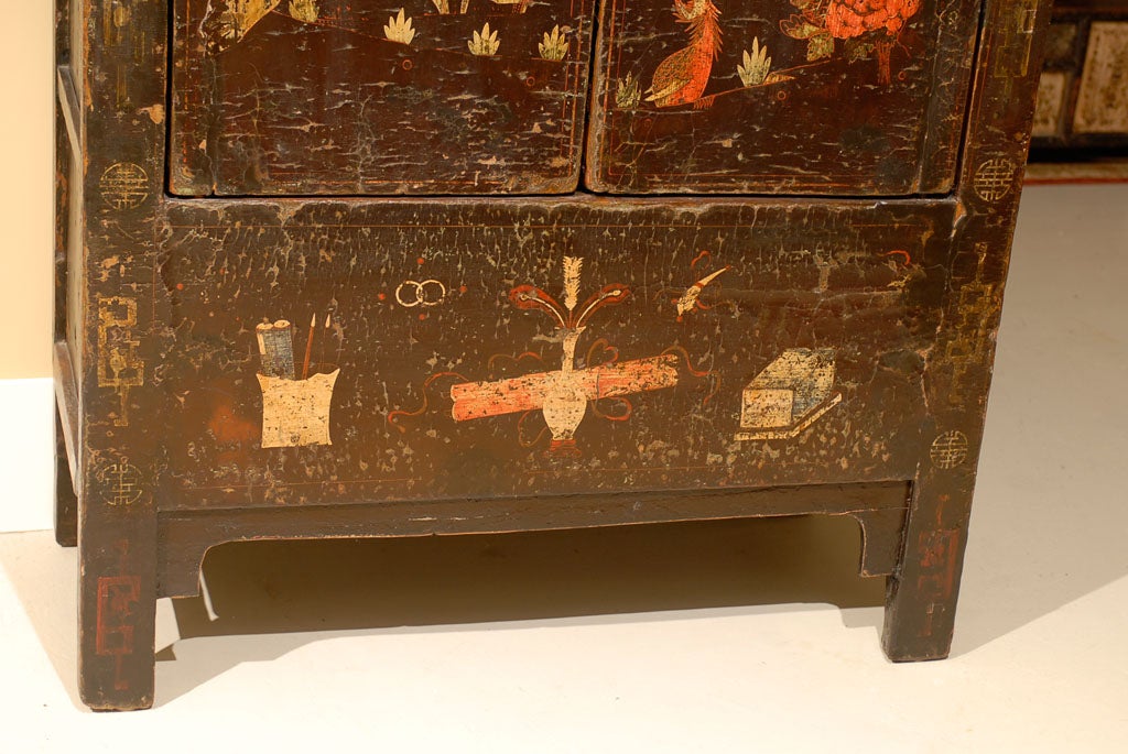 Black wedding cabinet with a depiction of a phoenix and peony.  The phoenix of Chinese legend symbolizes heaven's favor, happiness and luck.  While the peony represents female beauty and reproduction.