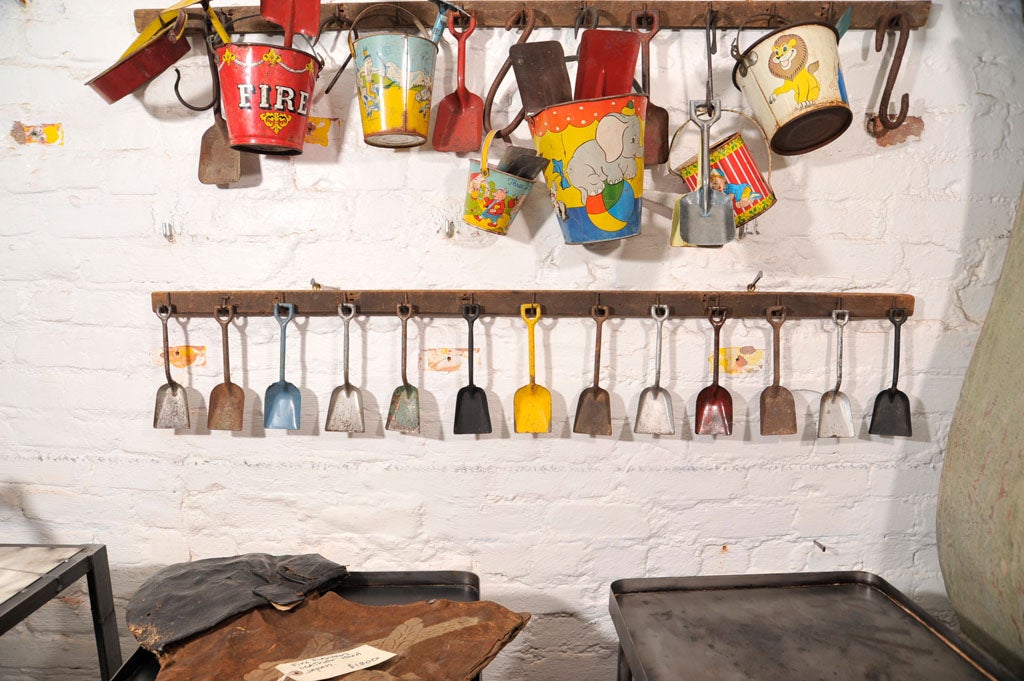 hand-painted shovels mounted on rack with iron hasps