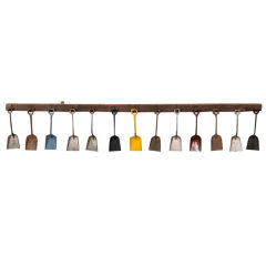 13  American Multicolored Sand Shovels on Oak Rack