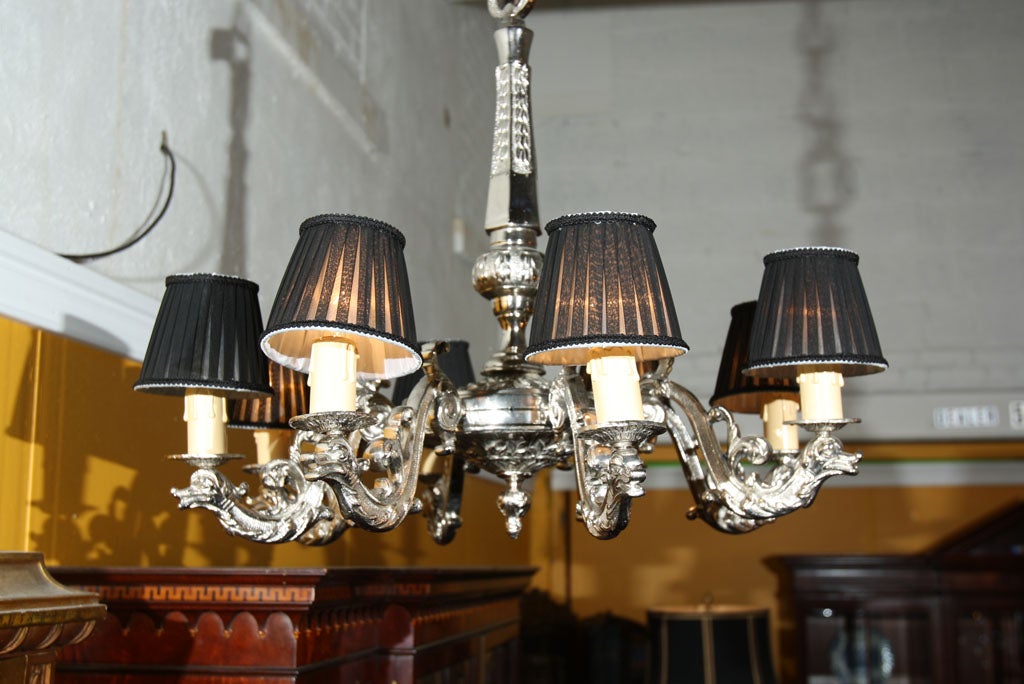 A silver overlay solid bronze eight-arm chandelier with black shades with swan decorations.