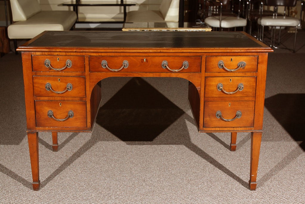 Beautiful Smith Watson leather-top desk. Seven drawers total.
