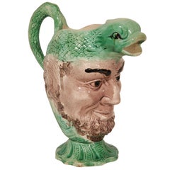 An 18th Century Creamware Dolphin Head Mask Jug