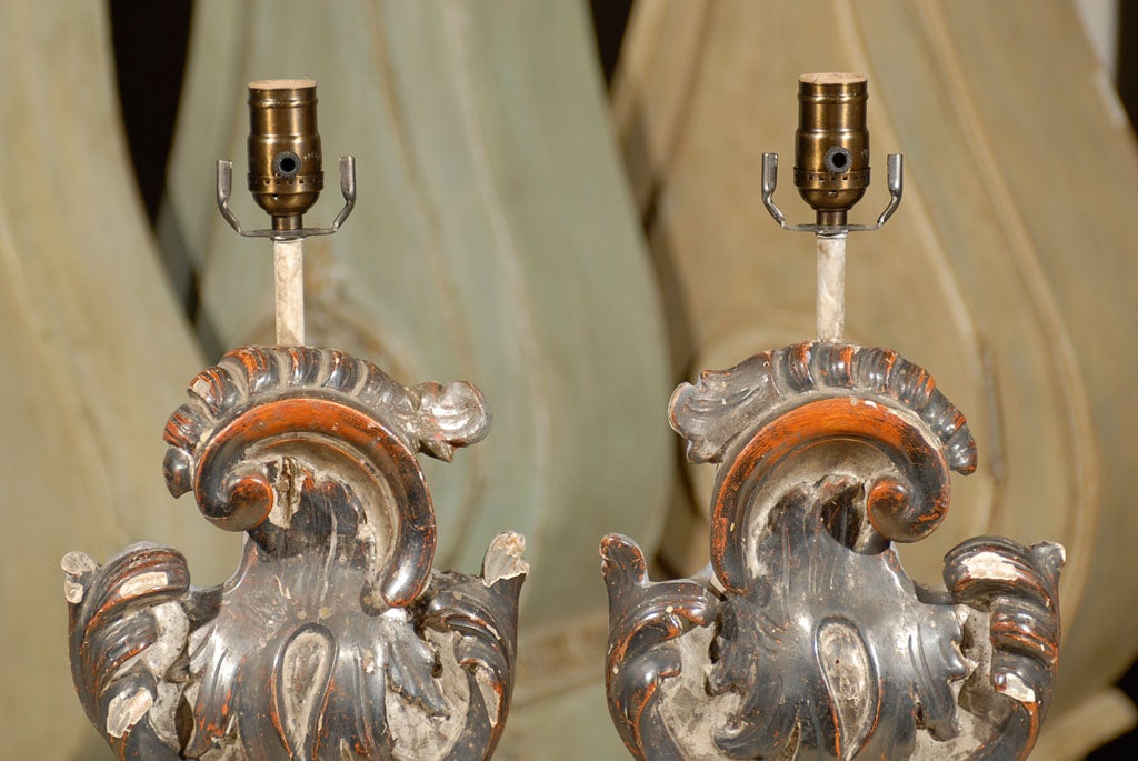 A pair of exquisite Italian Rococo style table lamps from the early 20th century.

This pair of hand-carved table lamps features Italian altar pieces that were converted into table lamps. From the early 20th century, these lamps are painted grey