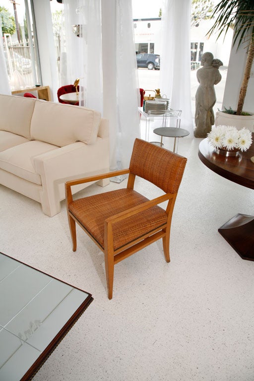 This interesting chair strongly recalls the design touch of T.H. Robsjohn-Gibbings. Gracefully tapered legs in a honey-blond finish, the original cane upholstery, and brass nailhead trim give the piece a warm, Classic look.



The chair was