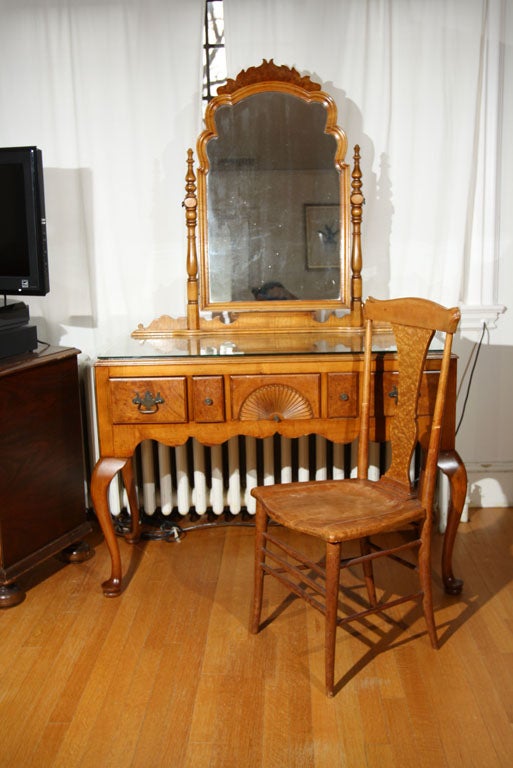 Tiger maple vanity and chair.  Five deep drawers.  Decorated carved mirror.  The mirror is attached and in very good condition.  The top and the drawers are birds eye maple. The apron is decorated in the front and on the sides.  There are other