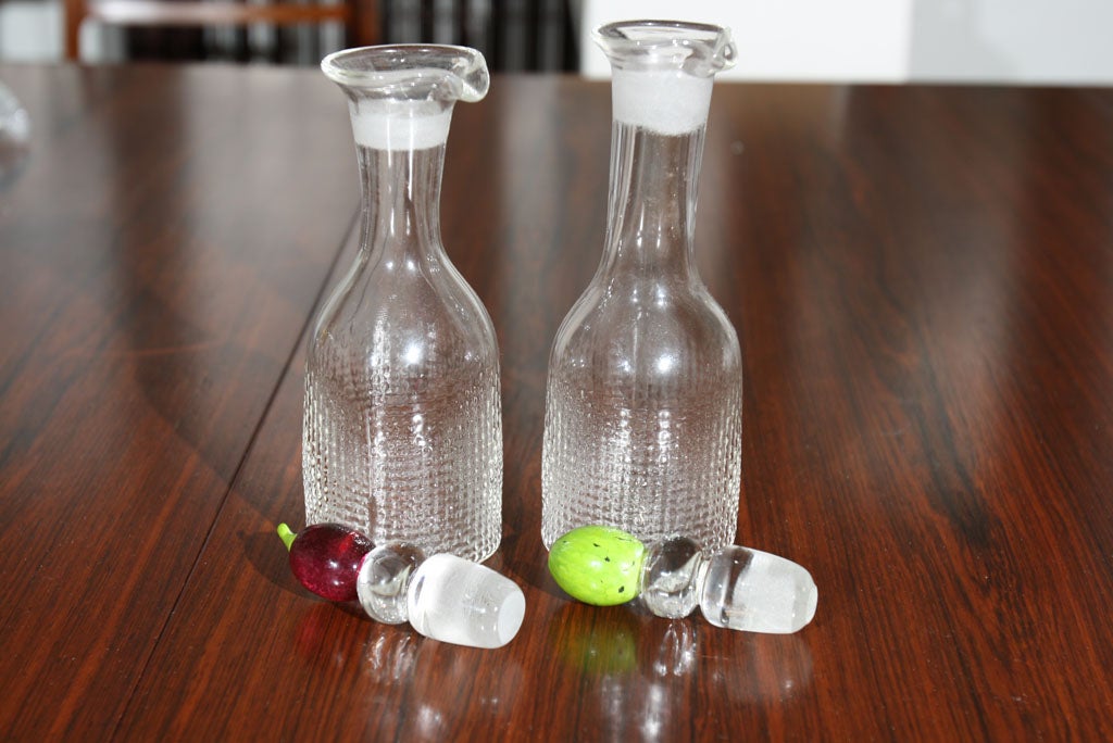 Hand blown and signed cruet set.  The Olive has a big pimento in it.  The grape has a long green stem.  There is a signiture on the bottom that I cannot make out.  It does say 1996.  There is a design going around the bottom rim of each bottle.