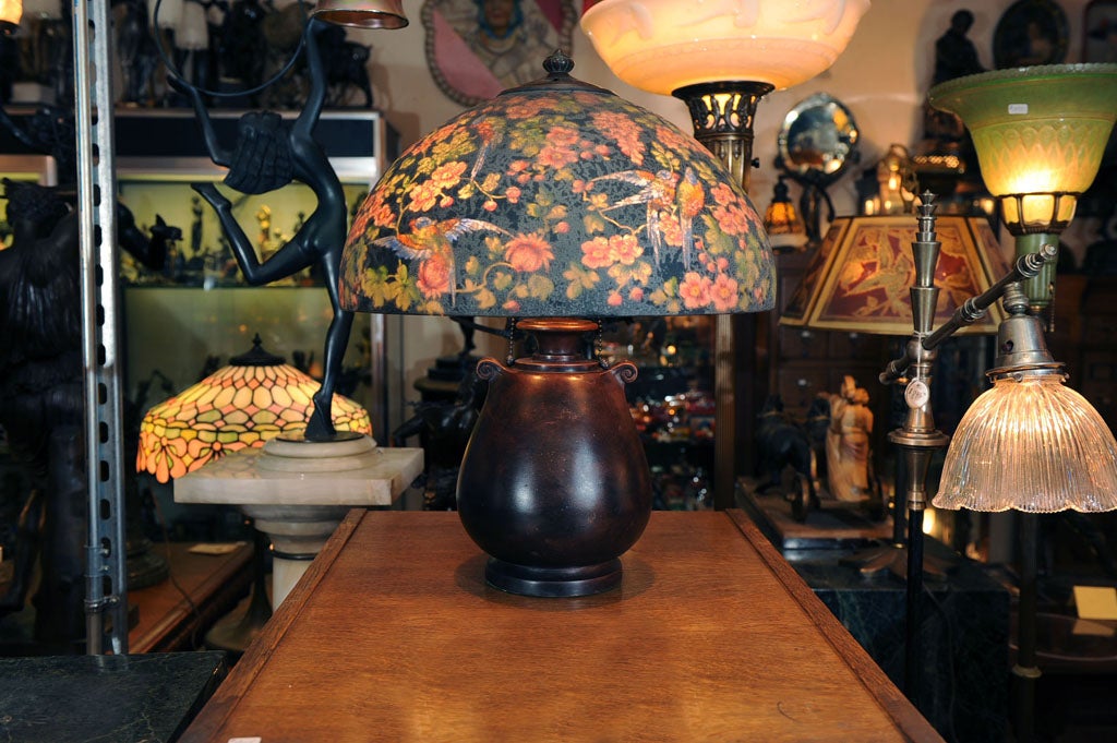 Here is one of Handel's finest examples of their reverse painted lamps.  This highly detailed, colorful lamp has a rare and desirable black background.  The shade is signed in two places, as shown in our photo.  This is a rare and highly sought