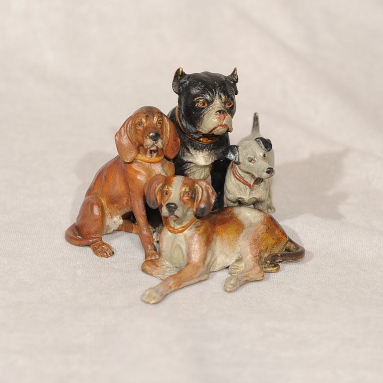 Highly collectible and colorful grouping of four bronze dogs is a rare and fine example of the Vienna bronzes. While it is unmarked, we guarantee this to be made in Austria and an old one.  A great addition to any collection of Vienna bronzes or dog