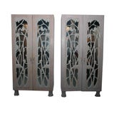 PAIR OF GRAND ARMOIRES WITH CARVED MIRRORED DOORS