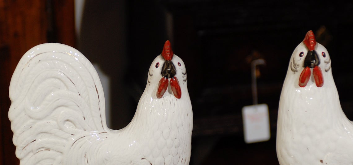 A matching pair of late 19th century Victorian ceramic affronted Staffordshire white roosters standing on shaped bases. One facing left and the other facing right, these two chimney ornaments present a flat rear side with vent holes, as they were
