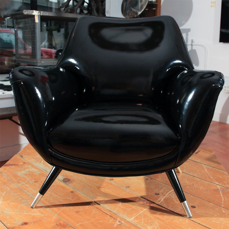 Sleek, chic and astonishingly comfortable pair of vintage armchairs freshly reappointed in a high-gloss black faux patent leather by Pollack on solid maple pencil-point legs.