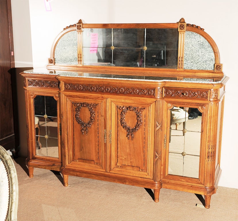 French Louis XVI style walnut 4-door, 3-drawer buffet with unusual section-mirroring on side doors,and backsplash, marble top and marble panels flanking mirror on backsplash.
