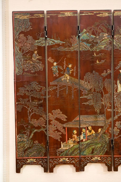 A rare 18th century Chinese Coromandel folding Screen of excellent small size showing people in various garden settings.
