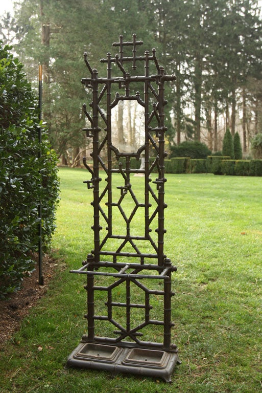 A cast-iron hall tree with faux bamboo design, bronze double pan insert, marked 